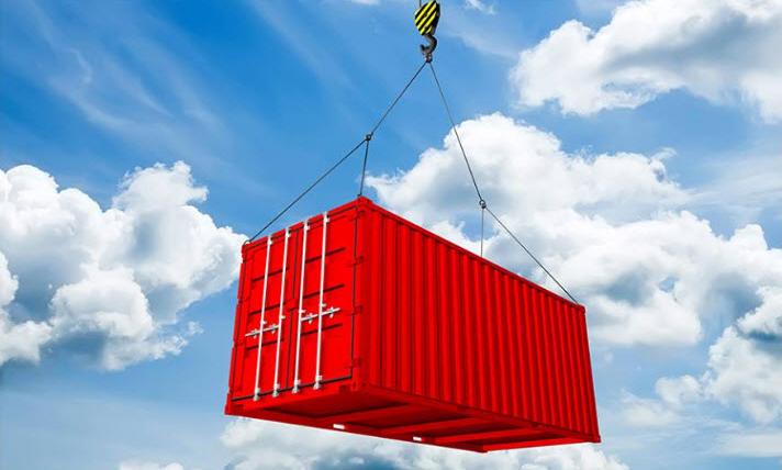 Red Container hanging from Crane used for international shipping